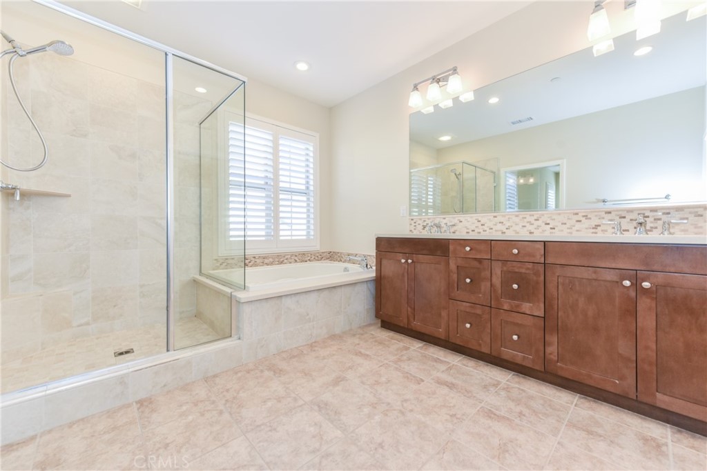 67 Elmdale Irvine, CA 92620 - Photo 22 of 39 a spacious bathroom with a tub sink shower and mirror