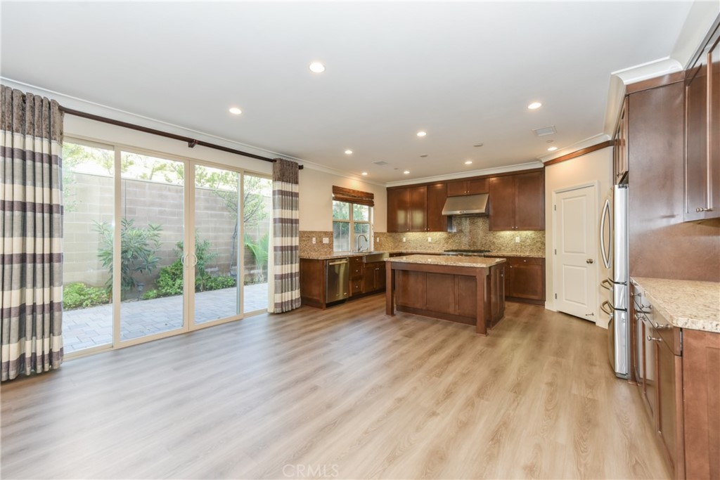 67 Elmdale Irvine, CA 92620 - Photo 3 of 39 a kitchen with stainless steel appliances a refrigerator a sink and wooden cabinets