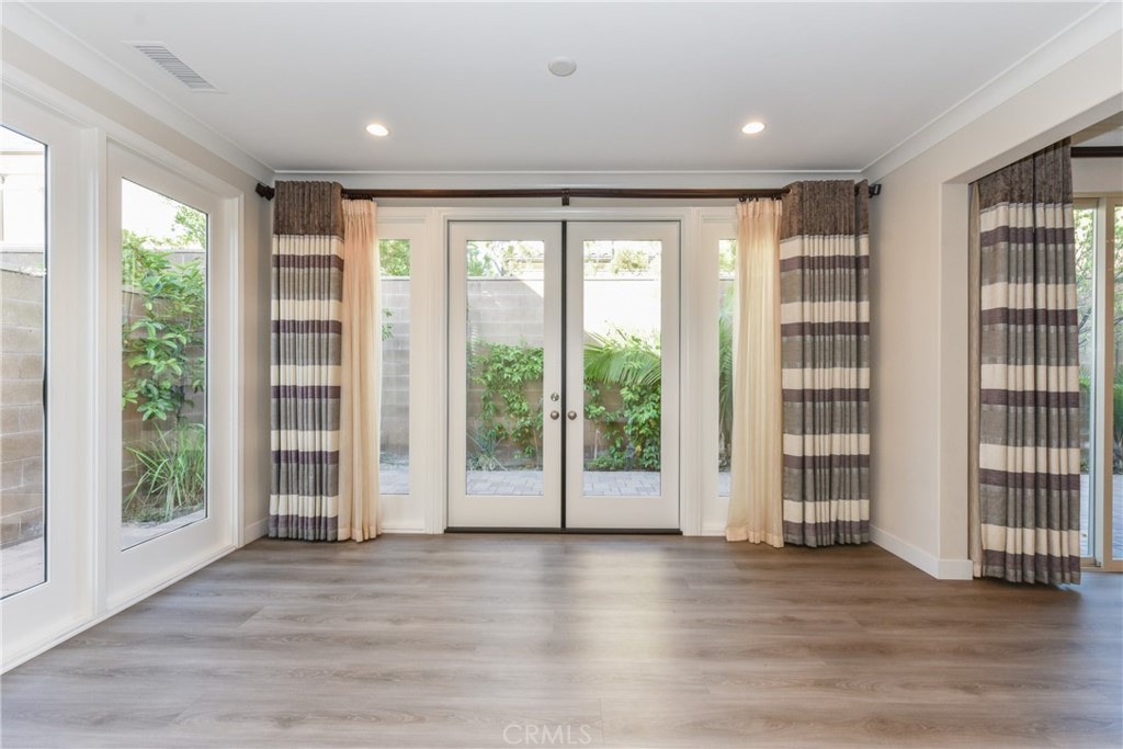 67 Elmdale Irvine, CA 92620 - Photo 5 of 39 a view of an empty room with wooden floor and a window