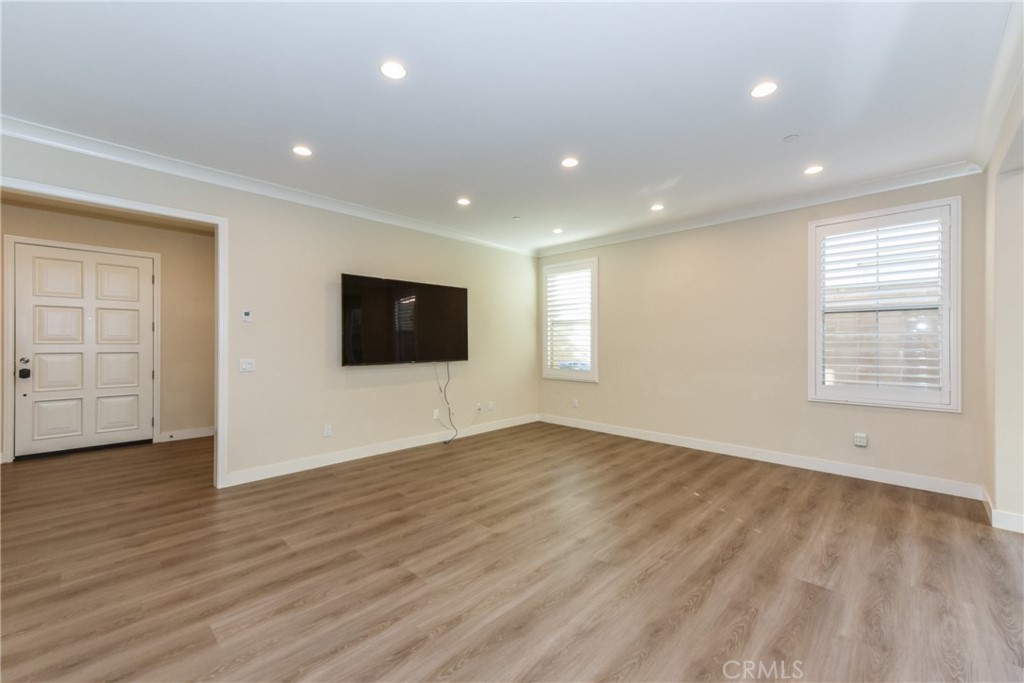 67 Elmdale Irvine, CA 92620 - Photo 6 of 39 a view of an empty room with wooden floor and windows
