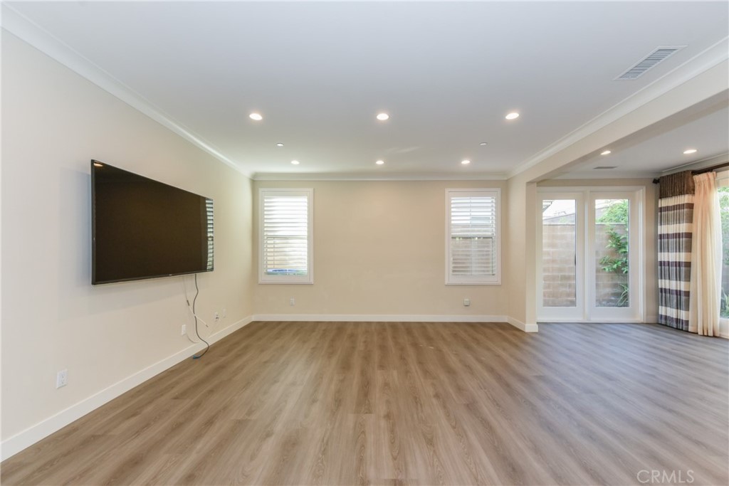 67 Elmdale Irvine, CA 92620 - Photo 7 of 39 an empty room with wooden floor and windows
