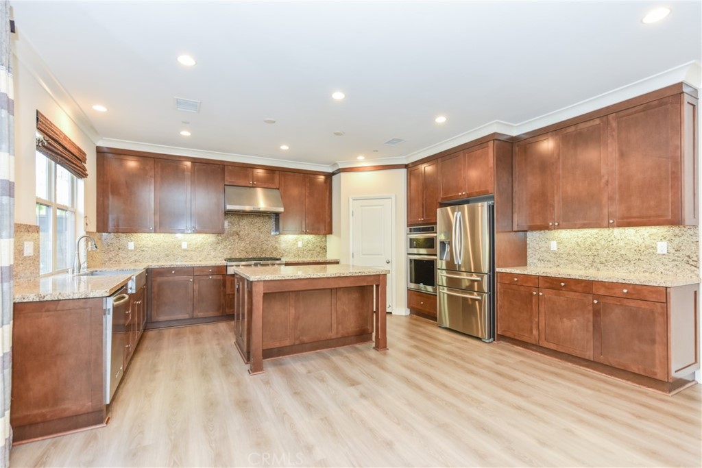 67 Elmdale Irvine, CA 92620 - Photo 9 of 39 a large kitchen with stainless steel appliances granite countertop a large counter top a stove and a sink