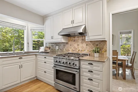 a living room with furniture floor to ceiling window and a potted plant