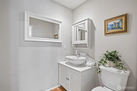 a bathroom with double vanity sinks and a mirror