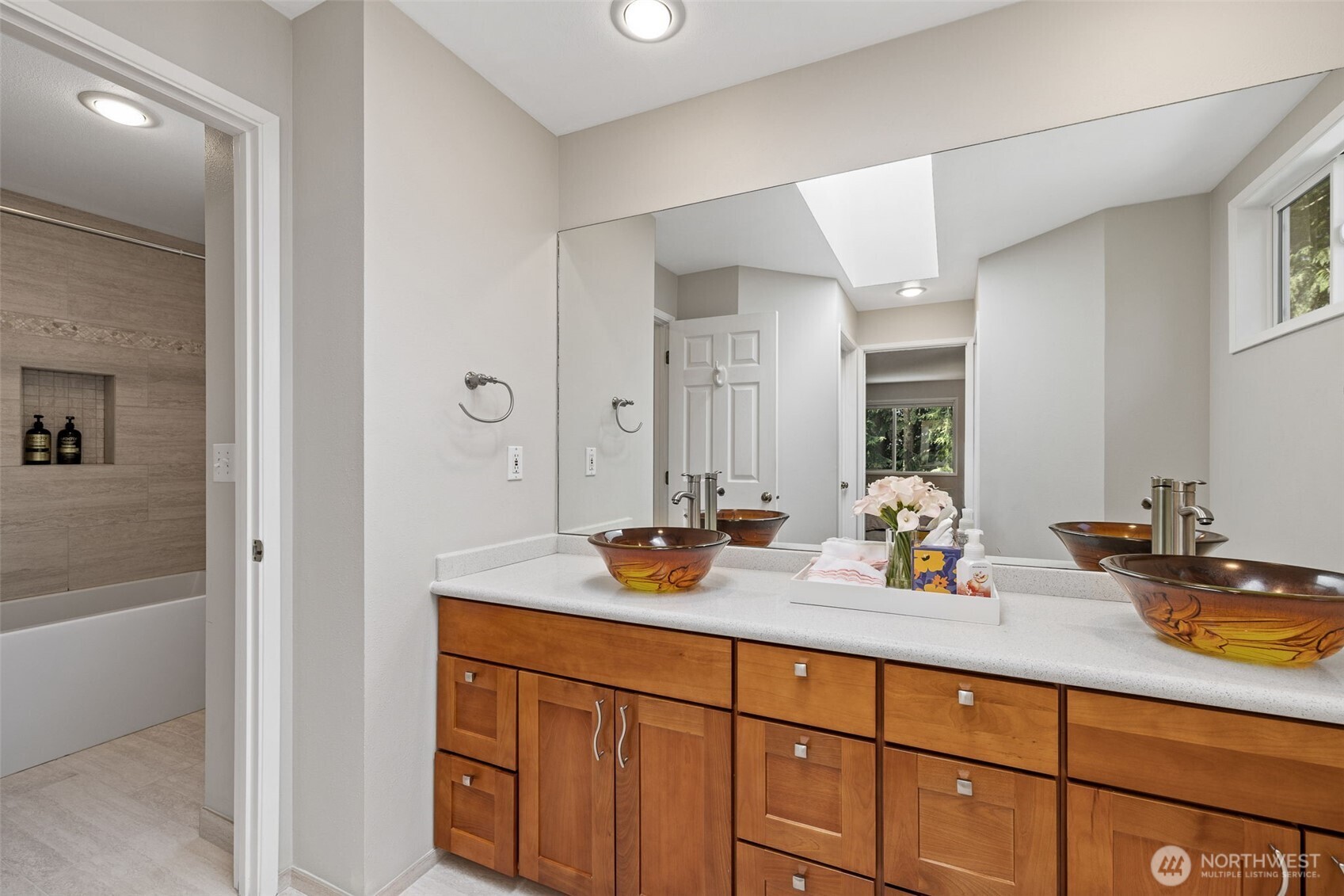 4310 209th Avenue Northeast Sammamish, WA 98074 - Photo 25 of 39 a bathroom with double vanity sinks and a mirror