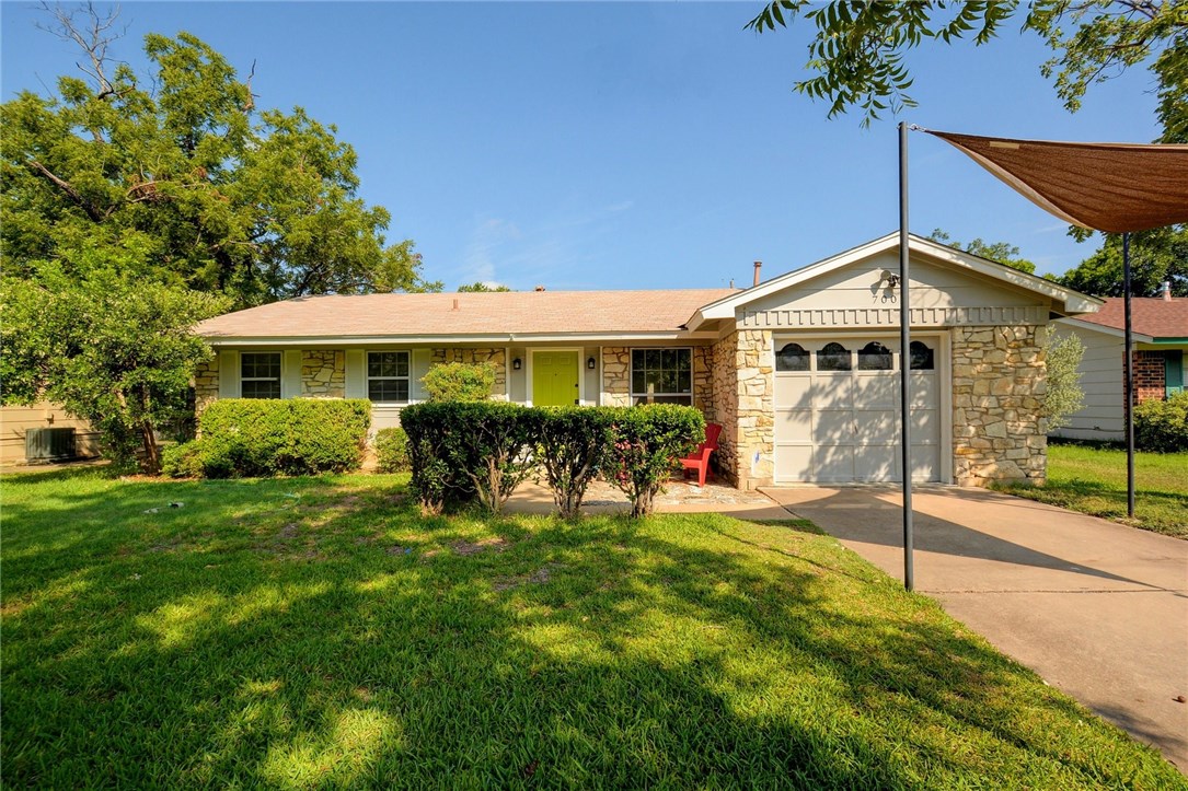 a view of a house with a yard porch and sitting area