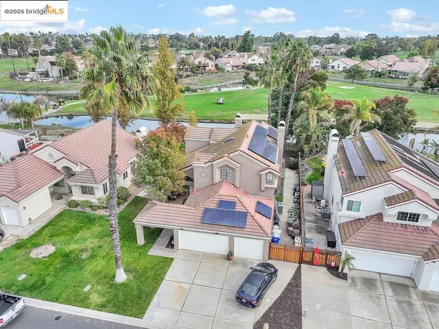 an aerial view of residential houses with outdoor space and street view