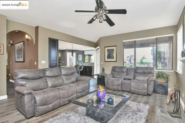 a kitchen with kitchen island granite countertop a sink cabinets and wooden floor
