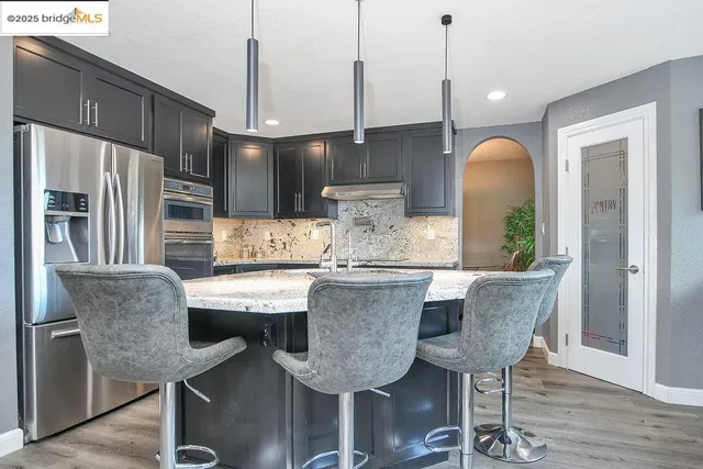 a bathroom with a sink and a large mirror next to a window