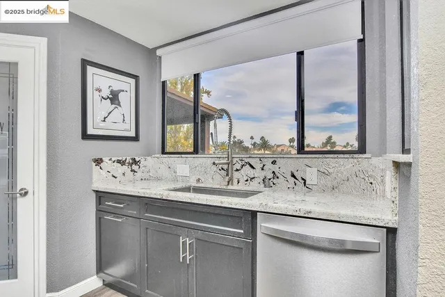 a kitchen with a sink stove and wooden cabinets