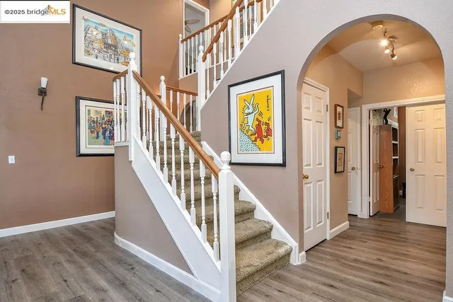 a bathroom with a granite countertop sink and a large mirror