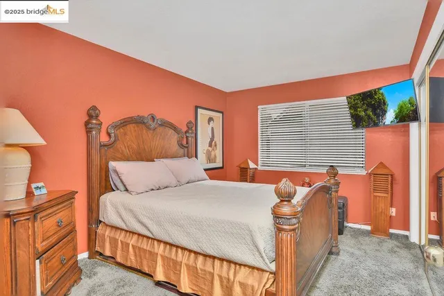 a bedroom with a large bed and wooden floor