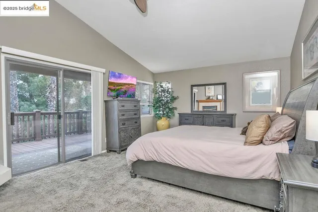 a bedroom with a large bed and a lamp