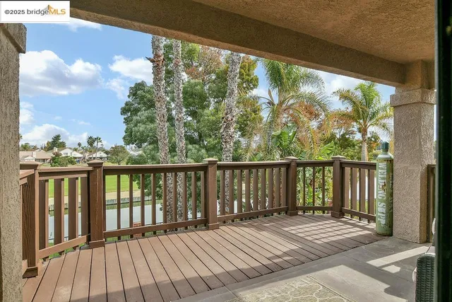 a balcony with wooden floor and outdoor space