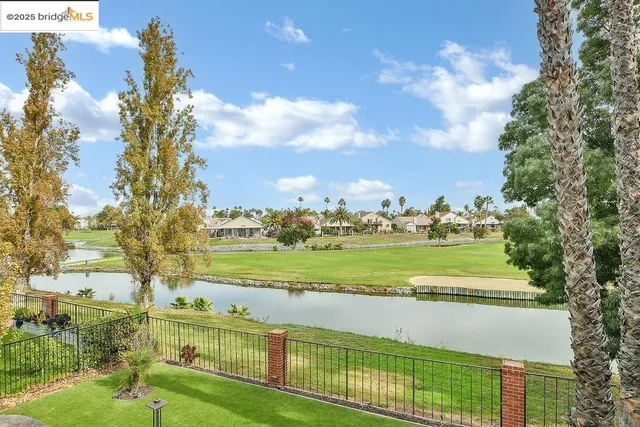 a view of a patio with a table chairs and backyard