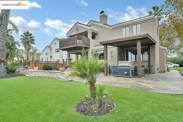 a front view of a house with a yard garden and outdoor seating