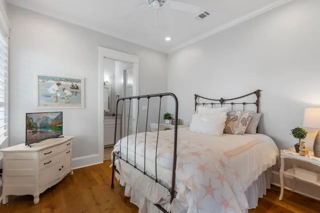 a bedroom with a bed and painting on the wall