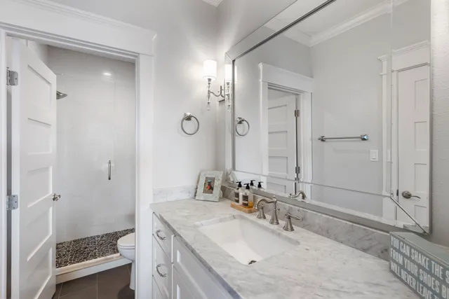 a bathroom with a sink double vanity granite tub and shower