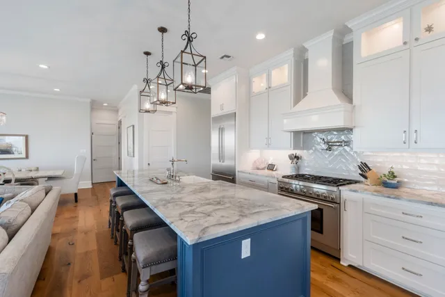 a kitchen with granite countertop kitchen island stainless steel appliances a sink stove and kitchen island