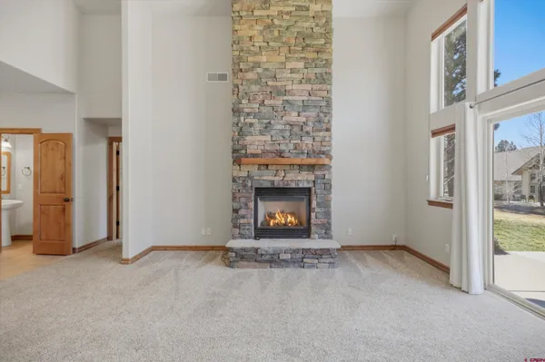 a kitchen with stainless steel appliances granite countertop a refrigerator a sink and dishwasher with wooden floor