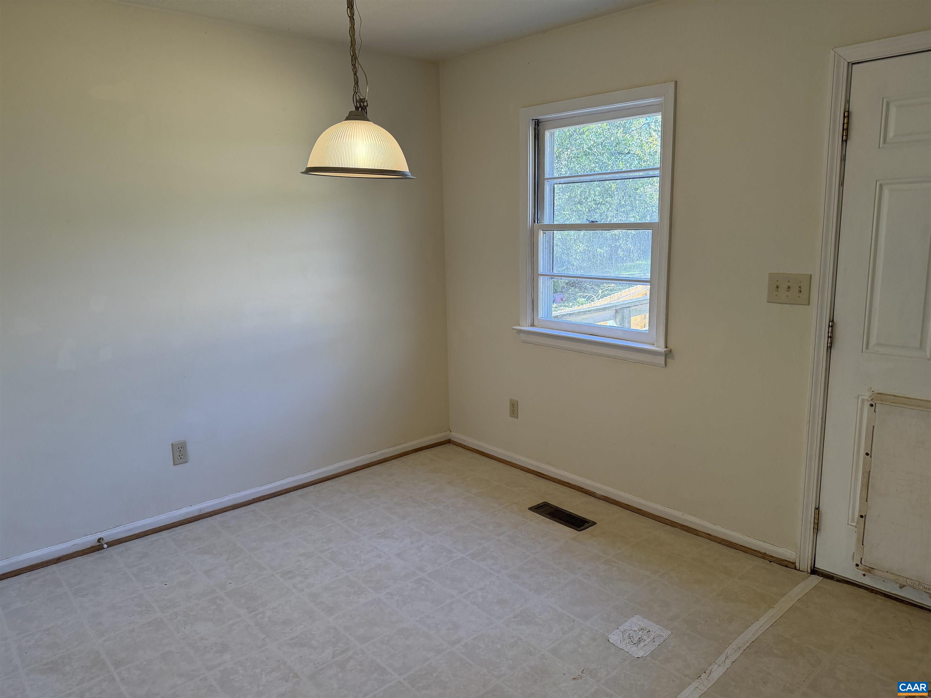 1453 Avon Street Charlottesville, VA 22902 - Photo 7 of 13 a view of an empty room with window and chandelier fan