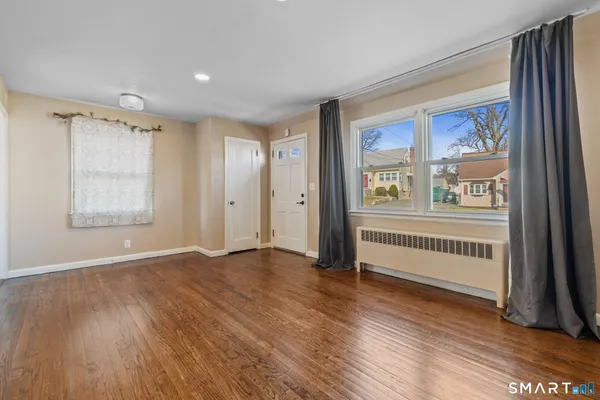 wooden floor in an empty room with a window