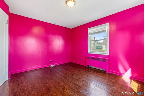 a view of a room with wooden floor and windows