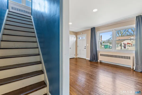 a view of an entryway with wooden floor