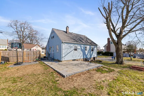 a view of a house with a yard covered in snow