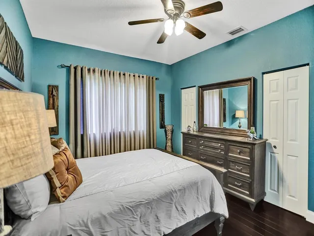 a bedroom with a large bed and a chandelier