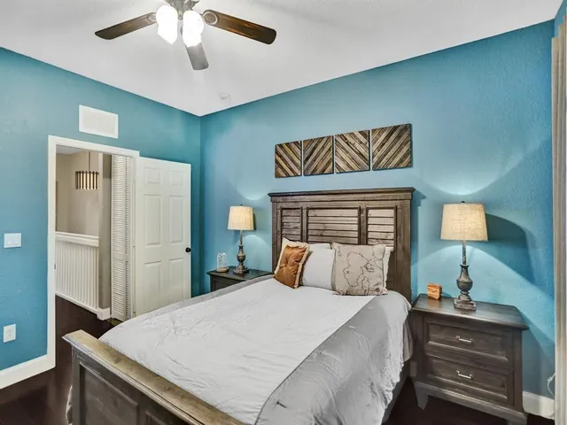 a bedroom with a bed and a lamp on table