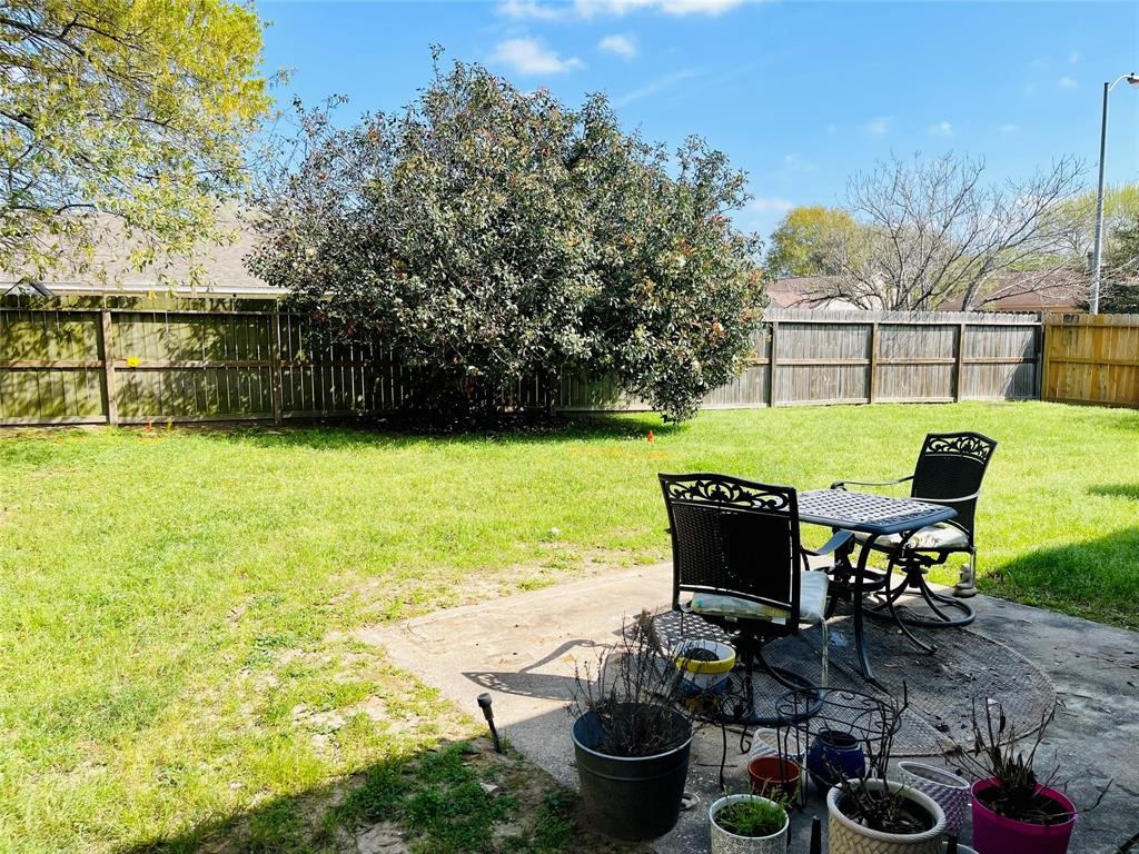 17002 Dew Drop Lane Houston, TX 77095 - Photo 14 of 14 a view of a patio with table and chairs potted plants and swimming pool