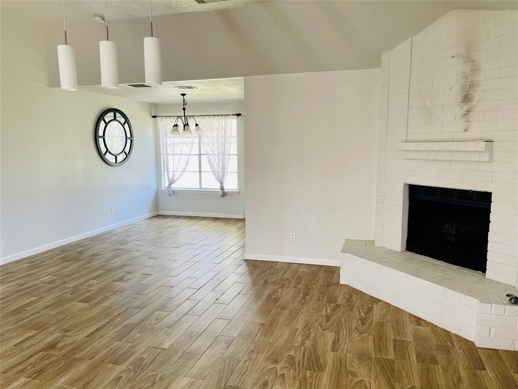 17002 Dew Drop Lane Houston, TX 77095 - Photo 3 of 14 a view of a livingroom with wooden floor and a fireplace