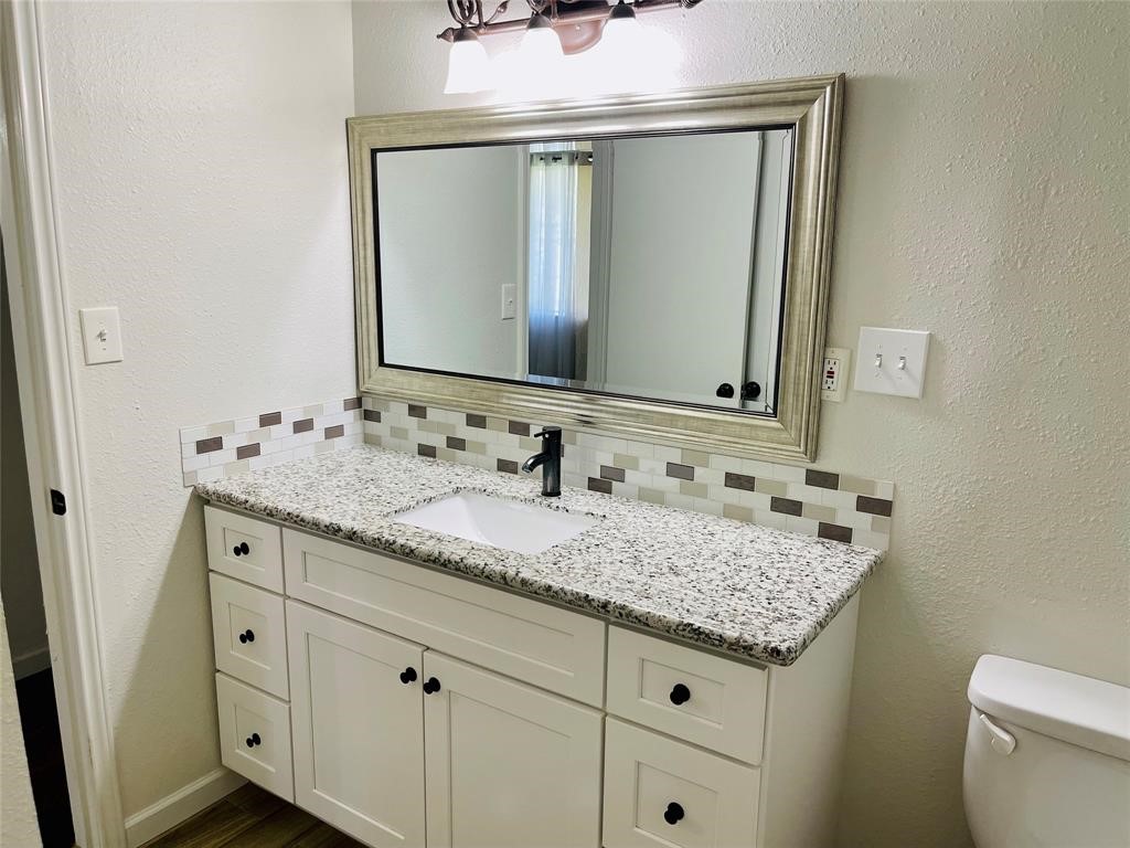 17002 Dew Drop Lane Houston, TX 77095 - Photo 8 of 14 a bathroom with a granite countertop sink and a mirror