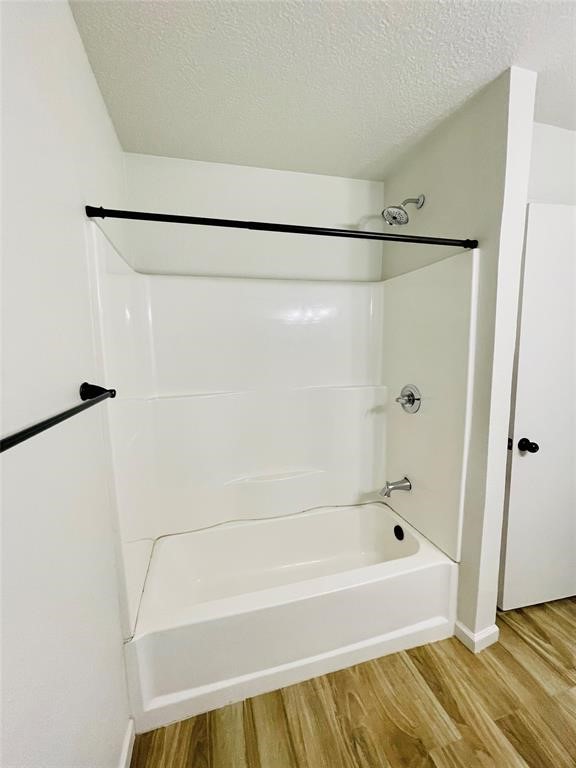 17002 Dew Drop Lane Houston, TX 77095 - Photo 9 of 14 a bathroom with a bathtub and a shower