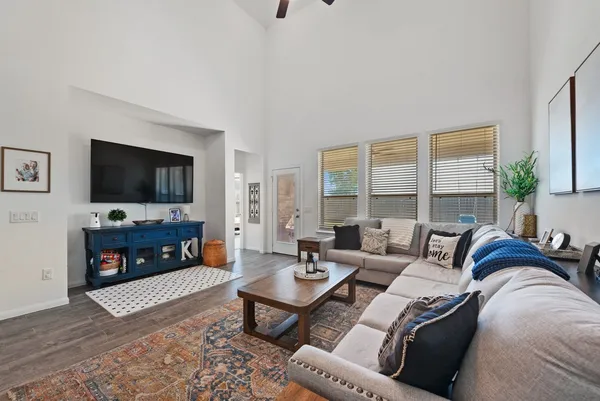 a living room with furniture a flat screen tv and a fireplace