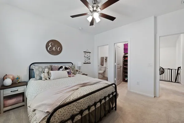 a bathroom with a toilet sink vanity and shower