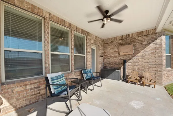a swimming pool with outdoor seating and yard