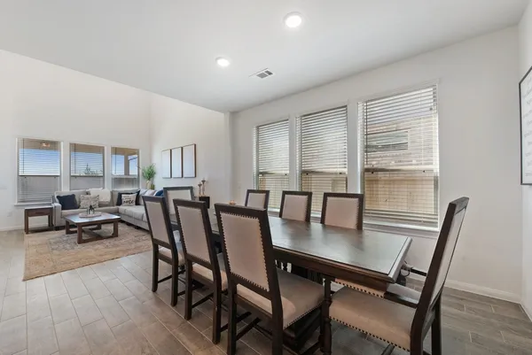 a view of a a dining room with furniture window and wooden floor