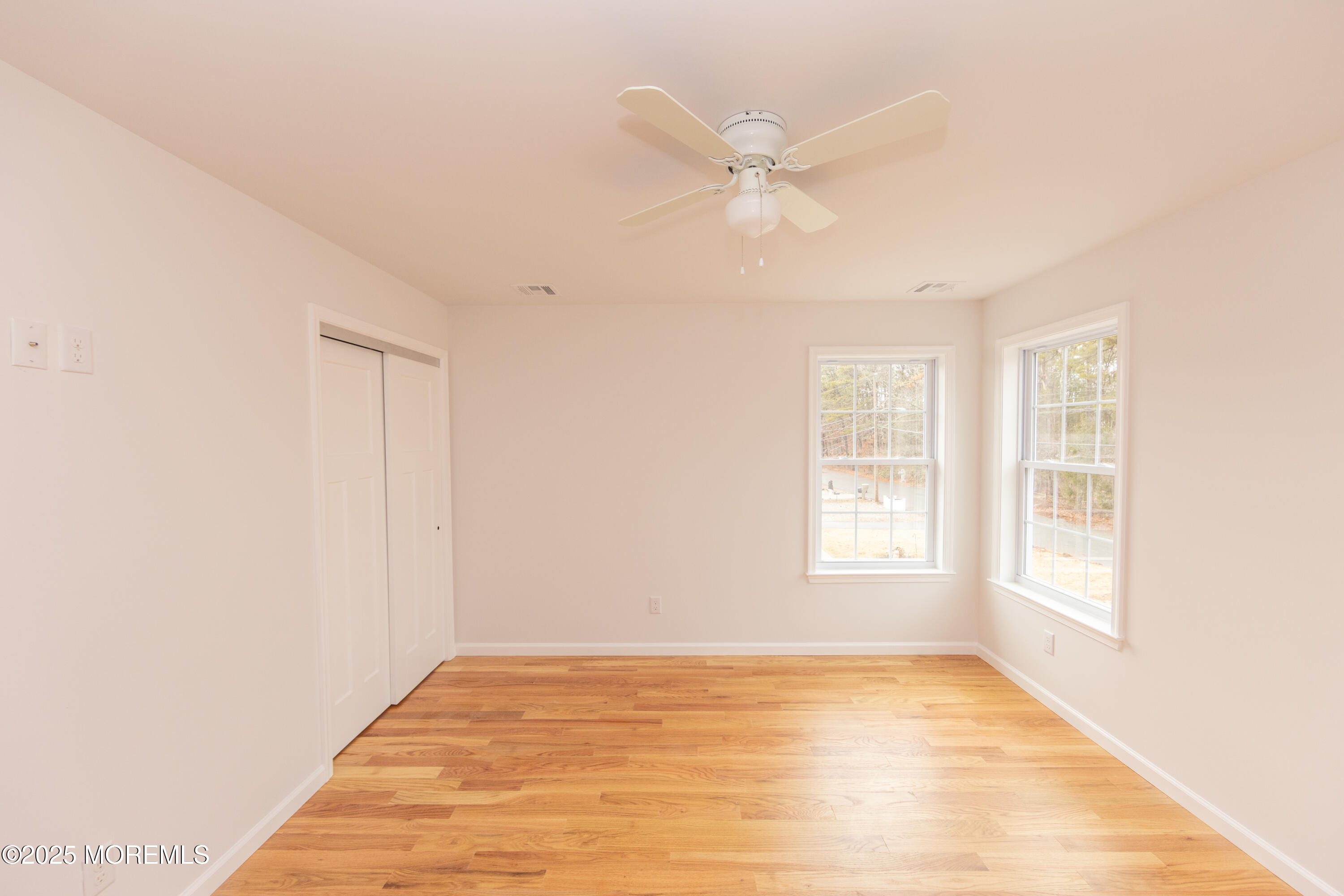 1517 Whitcomb Road Forked River, NJ 08731 - Photo 14 of 18 a view of an empty room with wooden floor and a window