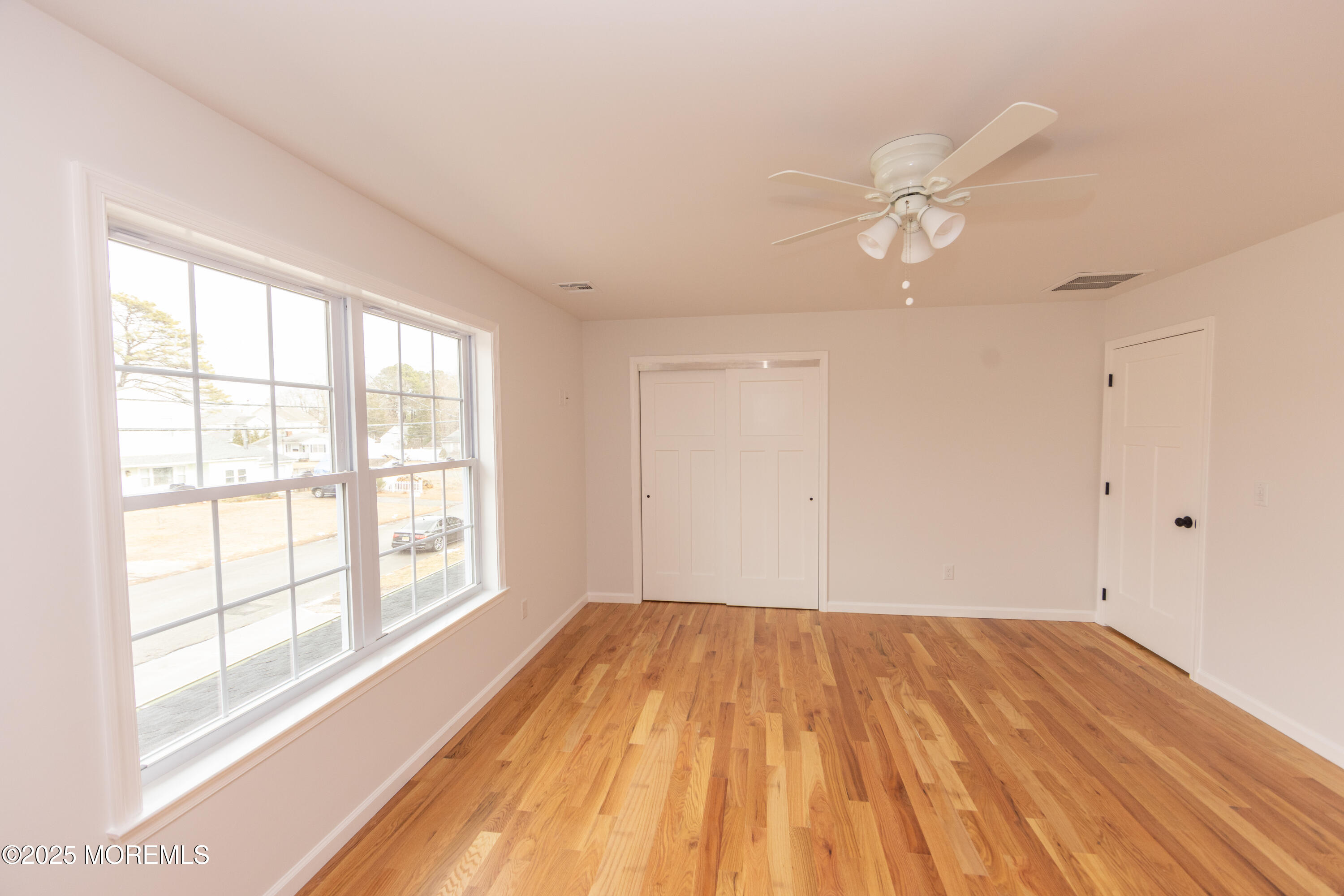 1517 Whitcomb Road Forked River, NJ 08731 - Photo 15 of 18 wooden floor in an empty room with a window
