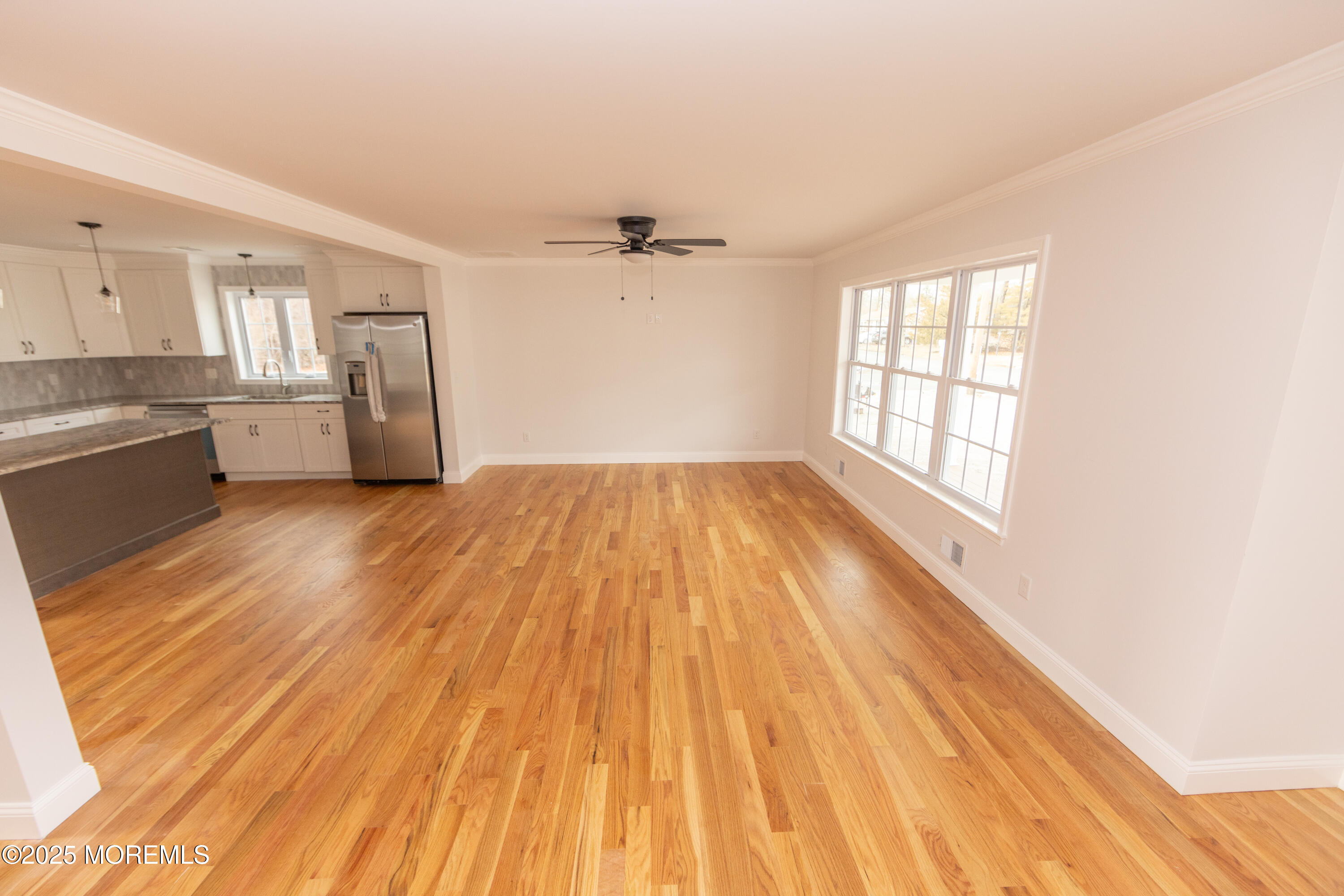 1517 Whitcomb Road Forked River, NJ 08731 - Photo 3 of 18 a view of empty room with wooden floor and fan