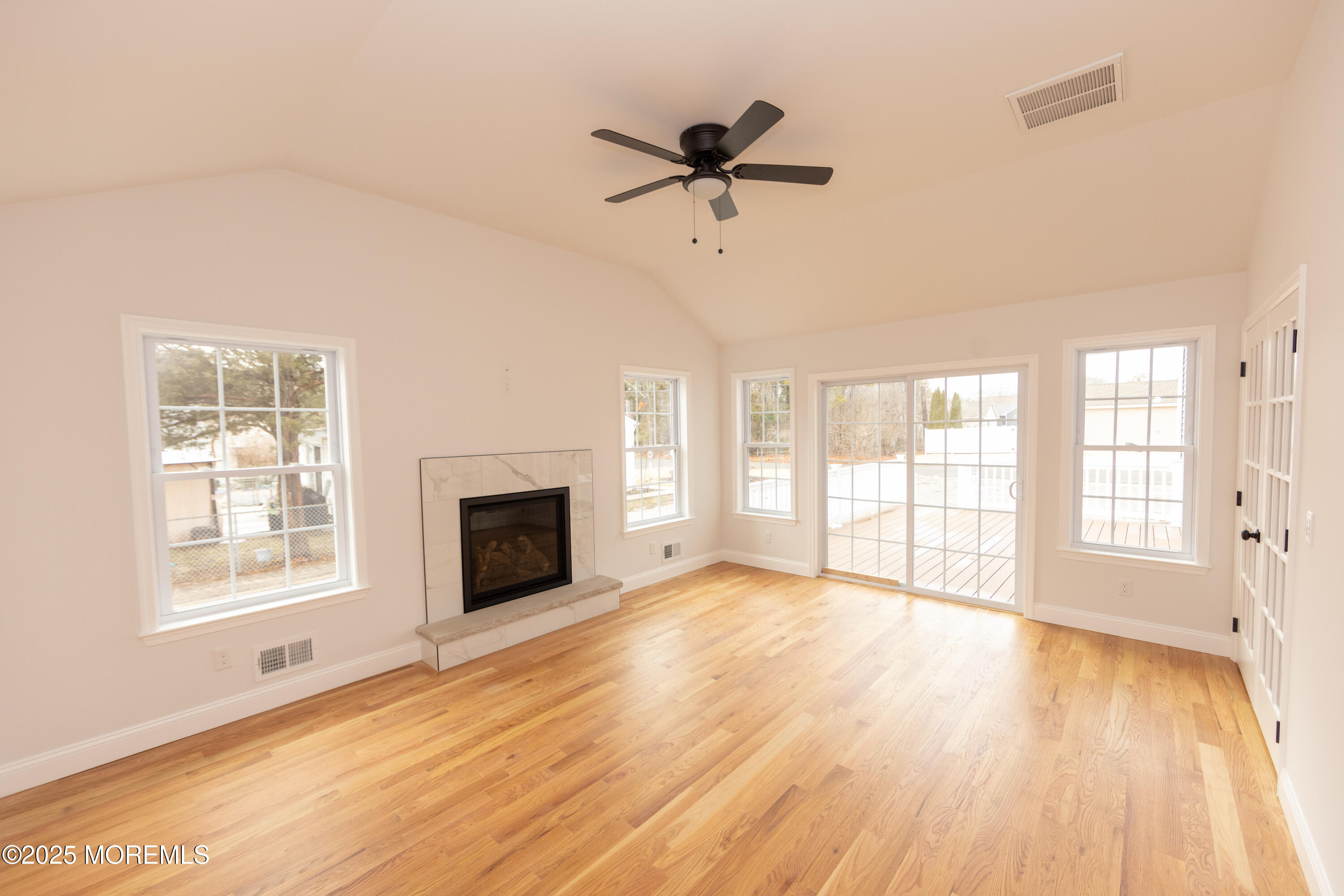 1517 Whitcomb Road Forked River, NJ 08731 - Photo 6 of 18 a view of an empty room with a fireplace and a window
