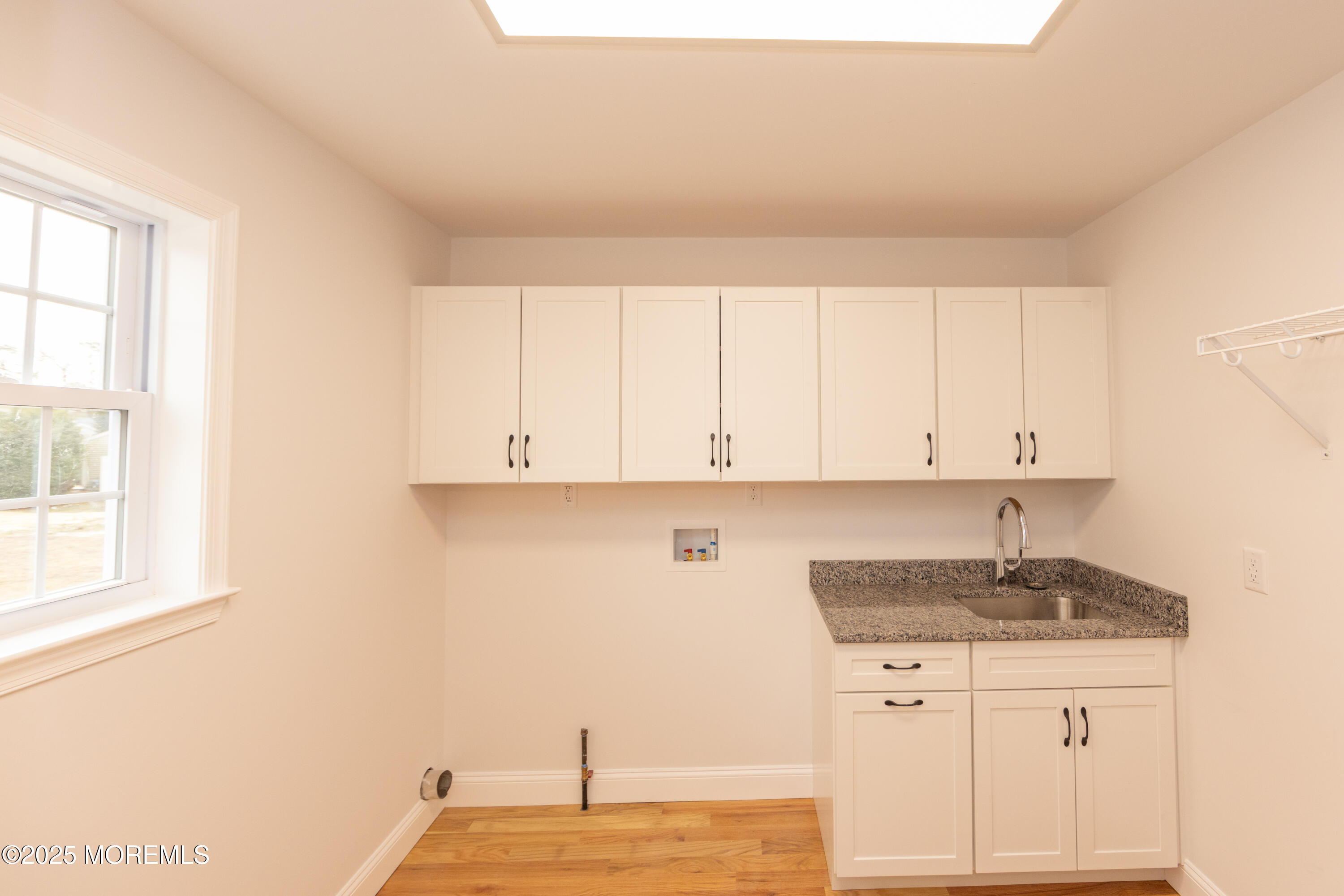 1517 Whitcomb Road Forked River, NJ 08731 - Photo 7 of 18 a kitchen with granite countertop white cabinets and a sink