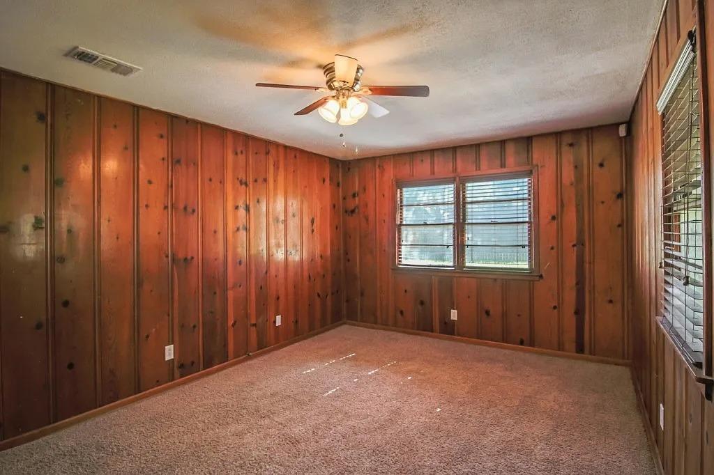 3011 37th Street Lubbock, TX 79413 - Photo 8 of 11 an empty room with windows and fan