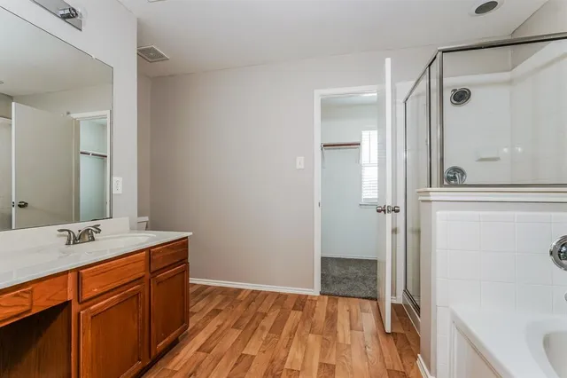 a bathroom with a sink a mirror and a shower
