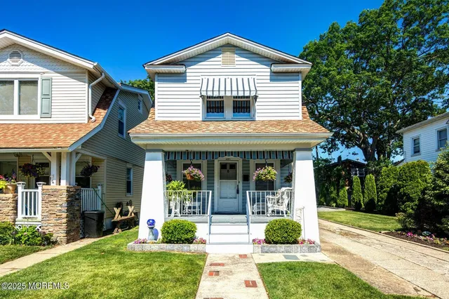a kitchen with white cabinets and sink