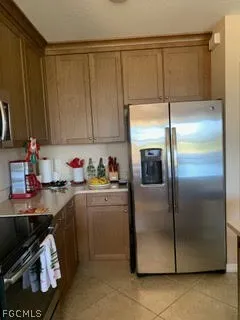 a kitchen with a refrigerator and cabinets