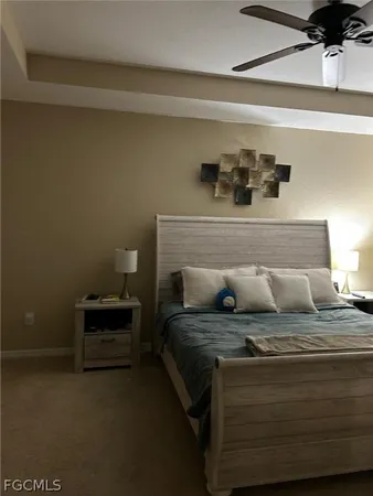 a bed sitting in a bedroom next to a lamp