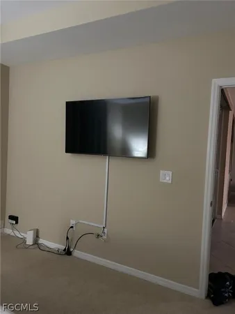a view of a livingroom with a flat screen tv and fan